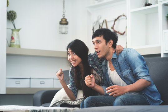 Asian Couple Watching TV.