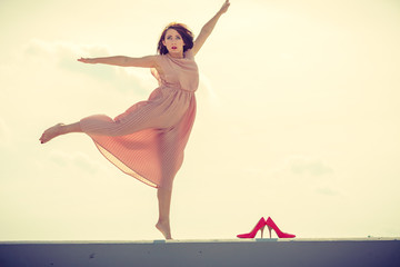 Fototapeta premium Woman dancing wearing long light pink dress