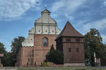 Gothic church facade with and wooden bell tower in Poznan.