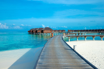 Fototapeta na wymiar beach with water bungalows at Maldives