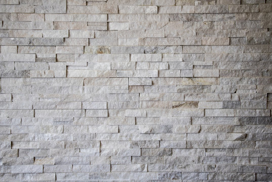 White texture rough cut stone wall background