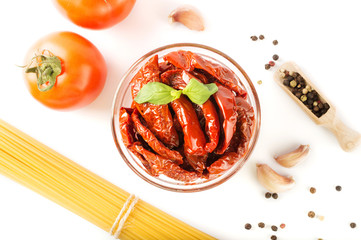 Spaghetti with ingredients for cooking pasta on a white background, top view