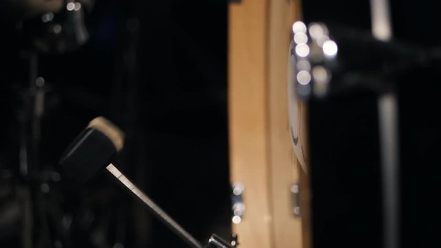 Bass drum pedal in action. Single kicks in the bass drum. Close-up footage. Looped video. Slowmotion.
