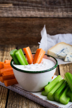 Fototapeta Mug of blue cheese garlic dip sauce with celery and carrot sticks