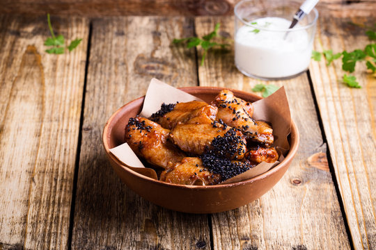 Glazed spicy chicken wings with sesame seeds