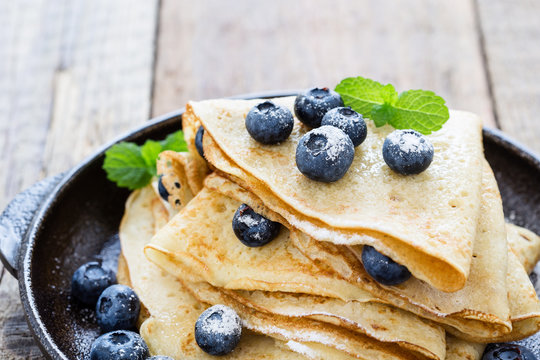 Crepes served with fresh blueberries and powdered sugar