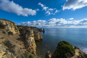 Obraz premium View of the sandstone cliffs at the Ponta da Piedade and the Lagos bay in Algarve, Portugal; Concept for travel in Portugal and Algarve