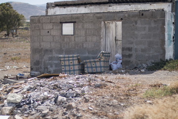 Abandoned shack with two seats.