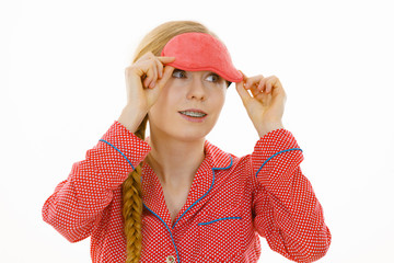 Sleepy woman wearing pink eye band