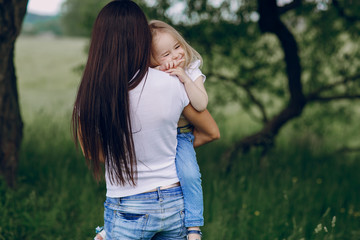 child near tree with mom