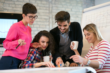 Business coworkers celebrate achieved goals in office