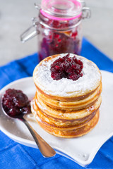 Homemade American pancakes served with red cranberry jam on blue napkin, Americal flag colors