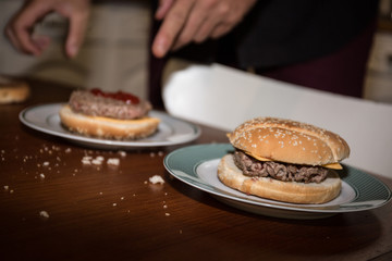 Homemade hamburger. Grilled beef patties, sesame buns with other ingredients for hamburgers on slate plate
