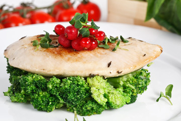 diet turkey fillet with boiled broccoli on a white plate decorated berries