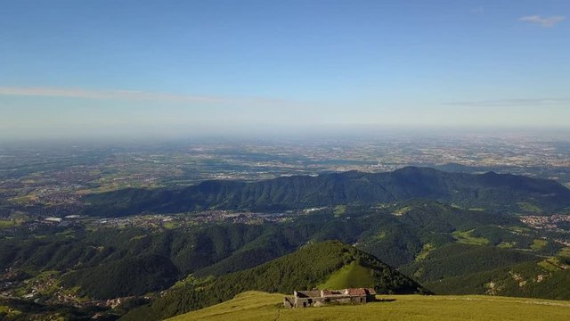 Superb 360&deg; landscape on the Padana plain and Alps in summer time. Panorama from Linzone Mountain, Bergamo, Italy. 