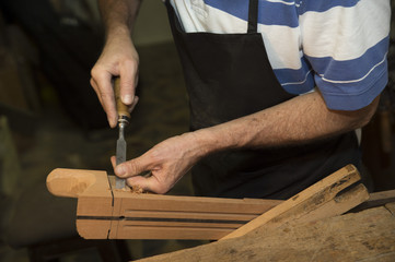 Man working at a Workshop with Musical instruments
