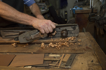 Man working at a Workshop with Musical instruments