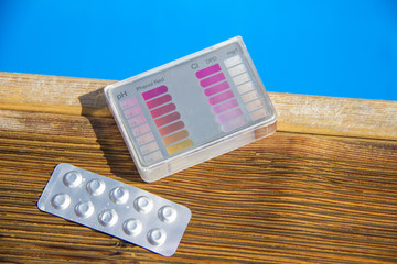 By the pool on a Sunny day throw in the tester for analysis of water pill.
