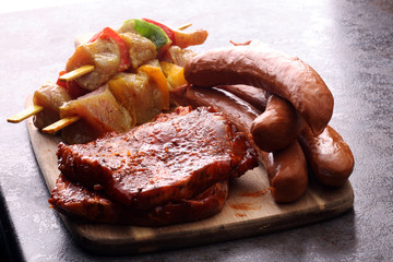 Selection of marinaded meat for bbq grilling with herbs on table