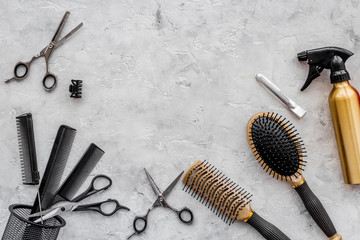 Hairdresser workplace. Combs and sciccors on grey table background top view copyspace
