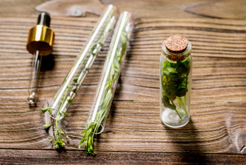 Fototapeta na wymiar Homeopathy. Store up medicinal herbs. Herbs in glass on wooden table background