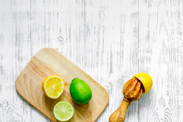 Make lemonade. Lemon, lime on wooden background top view copyspace