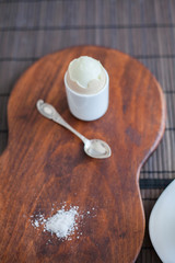 Boiled egg with toasts on a black wooden table