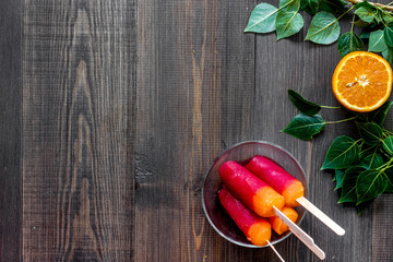 Orange and citrus ice cream on wooden table background top view copyspace