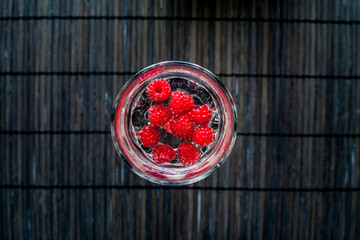 Sparkling raspberry lemonade water in a transparent glass