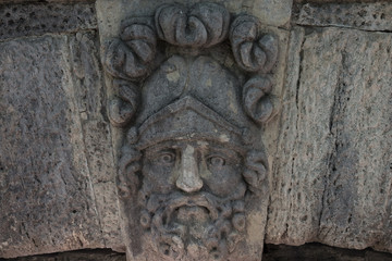Fototapeta na wymiar Masks of ancient gods, stone bas-reliefs, Catherine Park in Tsarskoye Selo, Pushkin, Russia