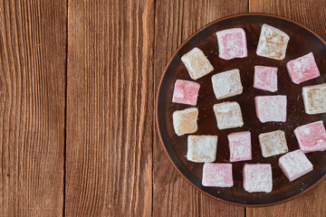 Delicious turkish delight on a wooden background