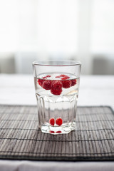 Sparkling raspberry lemonade water in a transparent glass