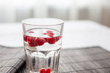 Sparkling raspberry lemonade water in a transparent glass