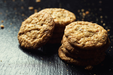 Biscuit sweet cookie background. Domestic stacked butter biscuit pattern concept,close up macro.Homemade cookies on wooden table.Cereal biscuits with the sesame,peanuts,sunflower and amaranth.