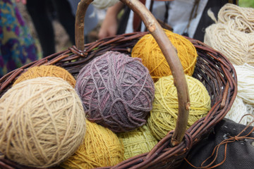 Colored wool dyed with herbs in a wicker basket