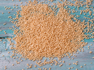 Amaranth seeds on wooden background.Macro shot