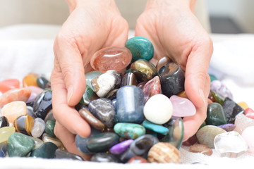 Hands holding tumbled stones