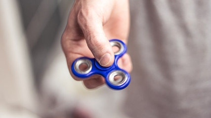The hand holds the spinner