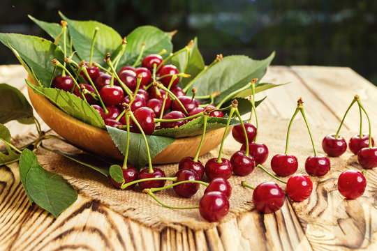 Cherries in basket on wooden table.Cherry. Cherries in bowl. Red cherry. Fresh sweet cherries with water drops,Close up.healthy food concept,soft focus