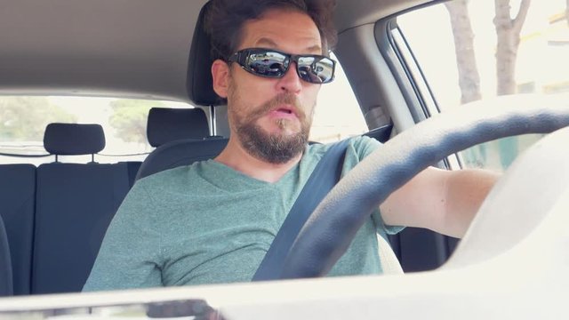 Man feeling stomach sick while driving car slow motion