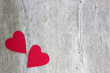 Two red hearts on a gray wooden background. Copy space.