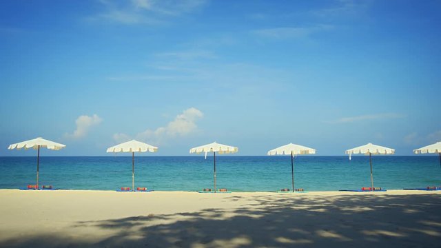 Row of White Umbrellas on Tropical Surin Beach, Phuket, Thailand