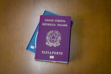 Italian and brazilian passports on wooden background