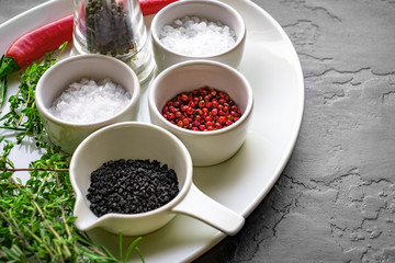 salt, pepper and herbs on a white plate