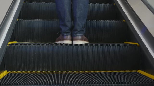Panning shot of A Man on a moving escalator