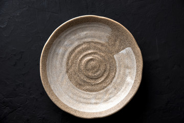 ceramic dish (plate) on dark table