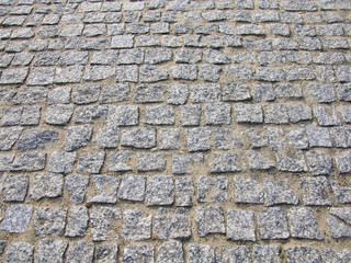 Stone pavement texture. Granite cobblestoned pavement background. Abstract background of old cobblestone pavement close-up. Seamless texture. Perfect tiled on all sides