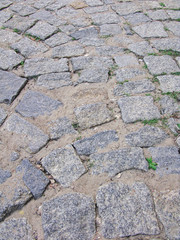 Stone pavement texture. Granite cobble stoned pavement background. Abstract background of old cobblestone pavement close-up