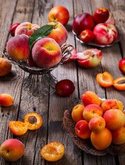 Naklejka na ściany i meble Apricots, Peaches. Fruits on a vintage wooden background.Food or Healthy diet concept.Super Food.Vegetarian.Copy space for Text.selective focus.