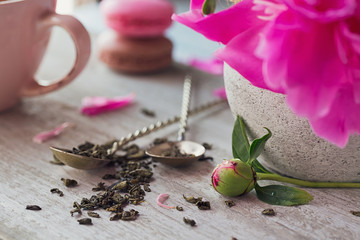 Still life with pink peony flowers and a cup of herbal or green tea © svittlana